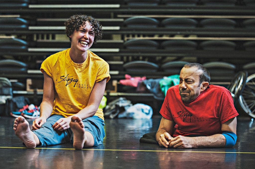 A photo of Amy and Dave sat side by side, Amy is laughing and Dave pulls a face.