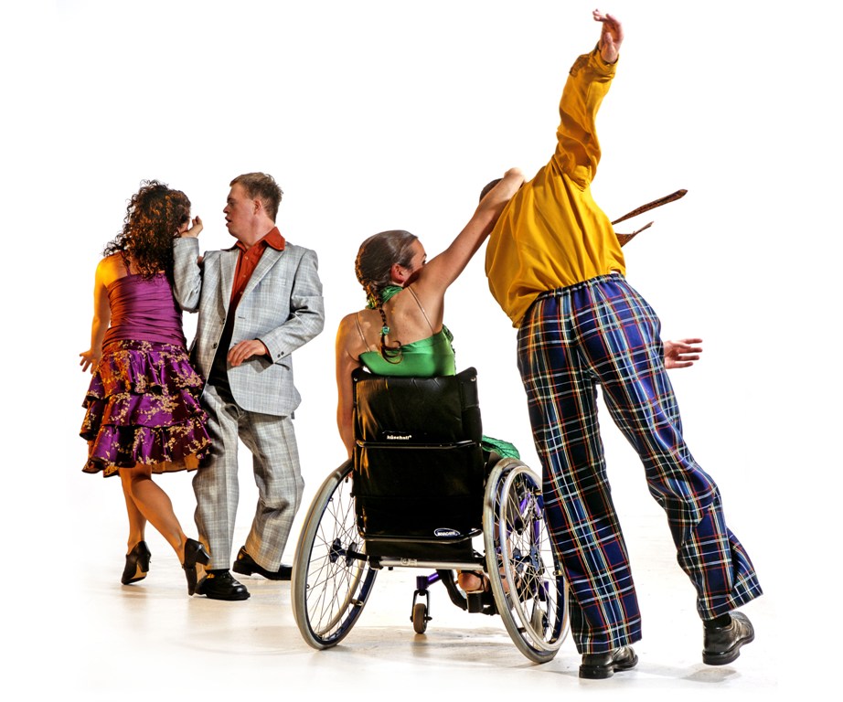 A photo from Corpus (2004), showing a group of three standing dancers and one wheelchair dancer.