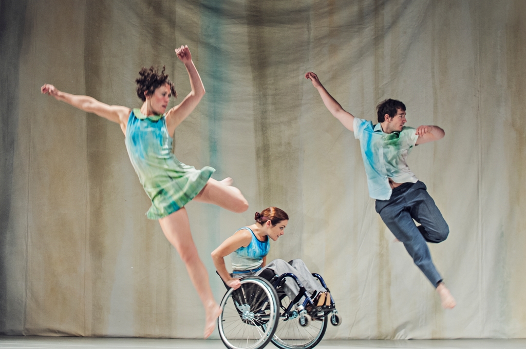 A photo from Artificial Things (2014) with two standing and one wheelchair dancer.