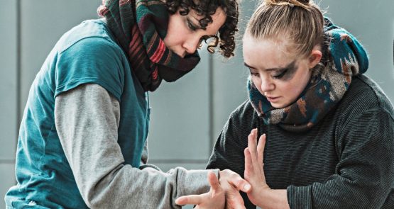 Amy and Hannah from the Awakening cast in an intricate duet of hands.