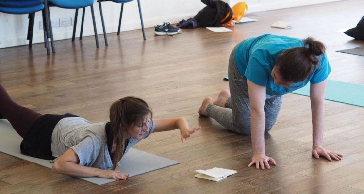 Two dancers in conversation whilst exercising. .