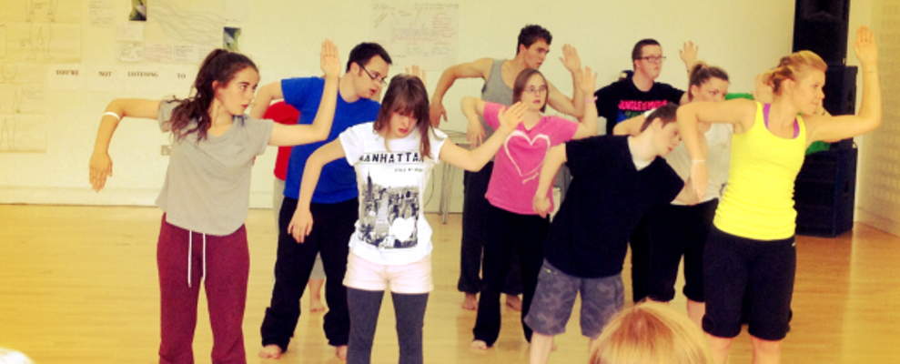 Members of a youth dance group dancing in the studio.