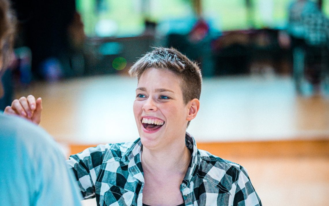 A woman with a large smile and short hair