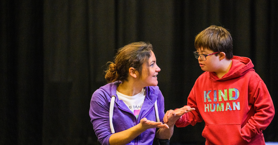 Co-Artistic Director Laura Jones talking to a young learning disabled dancer