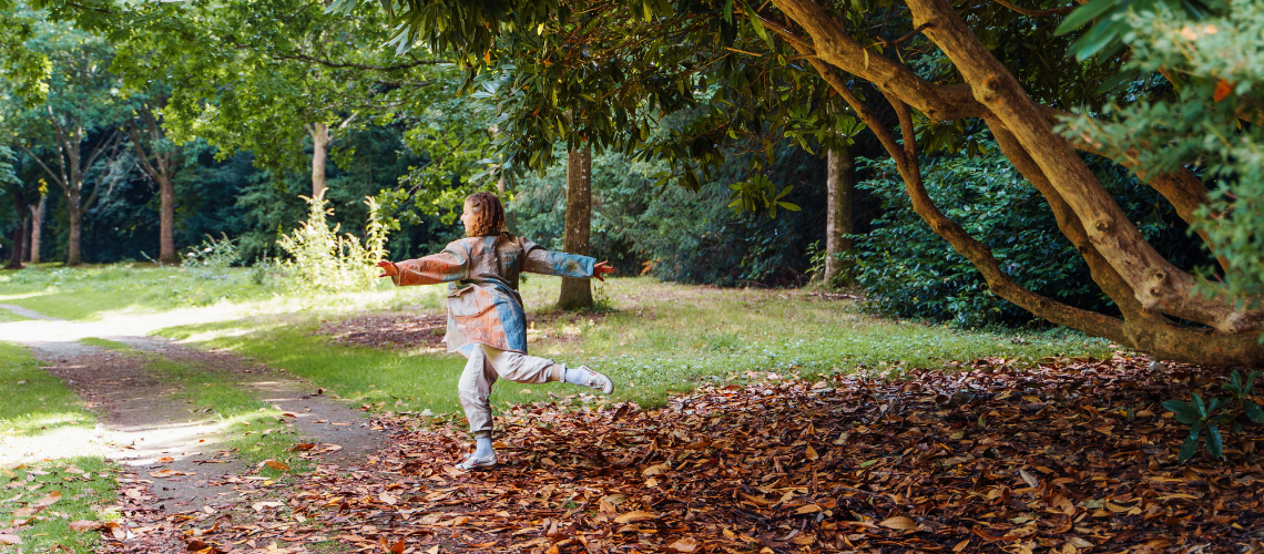 A dancer outside under a tree.
