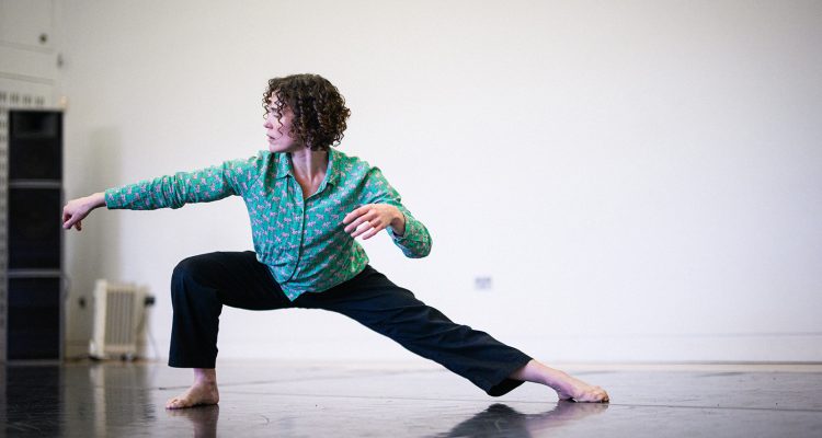 Amy Butler, a tall white woman, dancing in a studio
