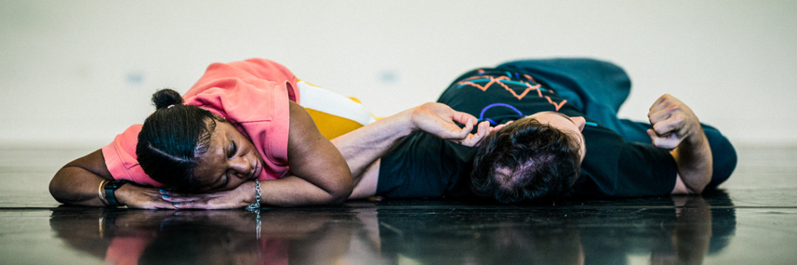 Two dancers resting on the floor.