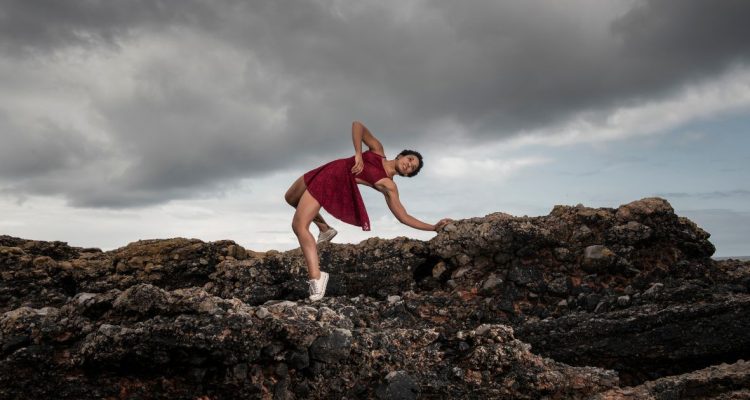 Dancer leaning back on some rocks